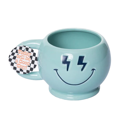 Light blue mug with smiley face design and lightning bolts, featuring a tag on a white background.